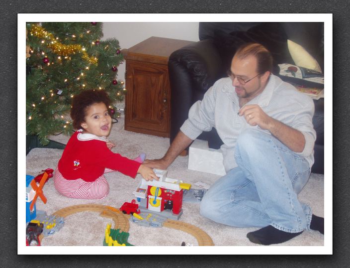 Kayla shows Daddy her new train set