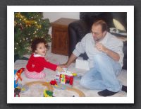 Kayla shows Daddy her new train set