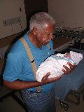 Grandpa Charles Holds His Precious Grandbaby