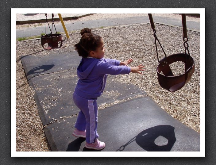 Kayla pushes the swing