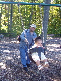 Daddy pushes Kayla in a Swing