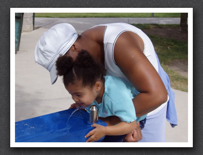 Mommy helps Kayla take a drink