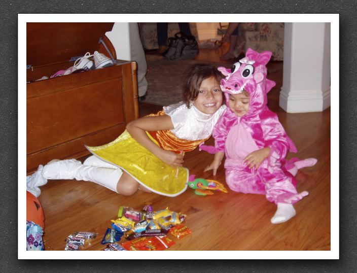 Gabrielle smiles, Kayla eyes the candy...