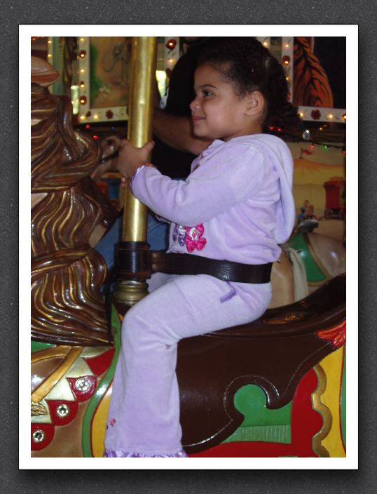 Little girl on the carousel