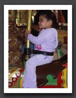 Little girl on the carousel